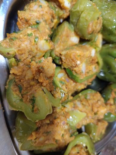 Tasty Bharwa Shimla Mirch cooked by COOX chefs cooks during occasions parties events at home
