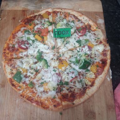 Tasty Veg Pizza cooked by COOX chefs cooks during occasions parties events at home