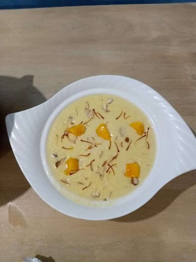 Tasty Mango Phirni cooked by COOX chefs cooks during occasions parties events at home
