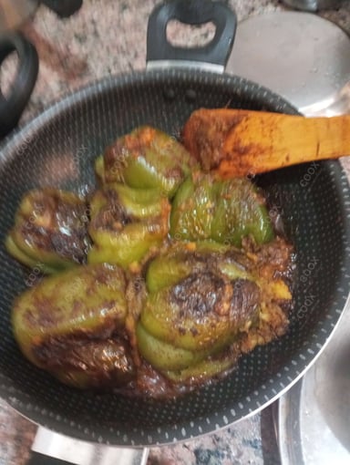 Tasty Bharwa Shimla Mirch cooked by COOX chefs cooks during occasions parties events at home