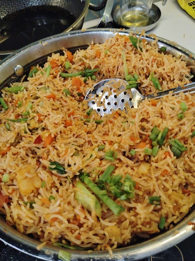 Tasty Schezwan Fried Rice cooked by COOX chefs cooks during occasions parties events at home