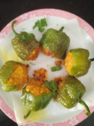 Tasty Bharwa Shimla Mirch cooked by COOX chefs cooks during occasions parties events at home