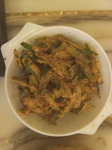 Tasty Kurkuri Bhindi cooked by COOX chefs cooks during occasions parties events at home