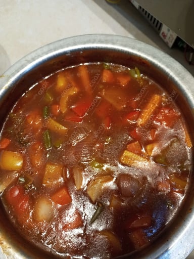 Tasty Mix Veg in Schezwan Sauce cooked by COOX chefs cooks during occasions parties events at home
