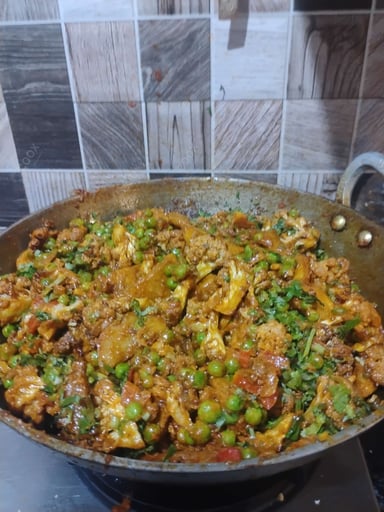 Tasty Gobhi Matar cooked by COOX chefs cooks during occasions parties events at home