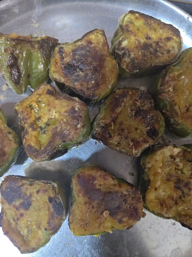 Tasty Bharwa Shimla Mirch cooked by COOX chefs cooks during occasions parties events at home