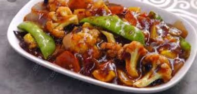 Tasty Mix Veg in Schezwan Sauce cooked by COOX chefs cooks during occasions parties events at home