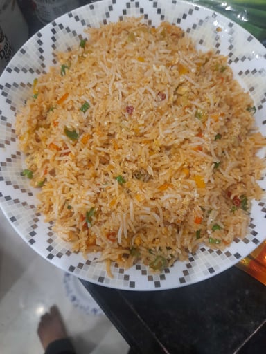 Tasty Chicken Schezwan Fried Rice cooked by COOX chefs cooks during occasions parties events at home
