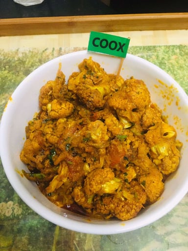 Tasty Adraki Gobhi cooked by COOX chefs cooks during occasions parties events at home