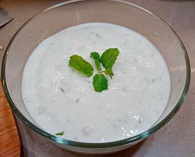 Tasty Cucumber Raita cooked by COOX chefs cooks during occasions parties events at home