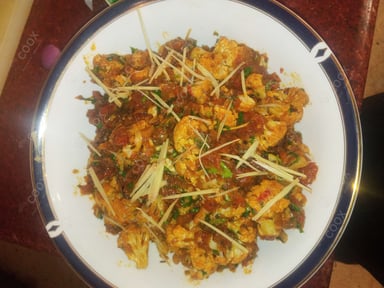 Tasty Adraki Gobhi cooked by COOX chefs cooks during occasions parties events at home