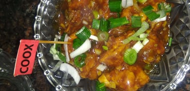 Tasty Chicken in Schezwan Sauce cooked by COOX chefs cooks during occasions parties events at home