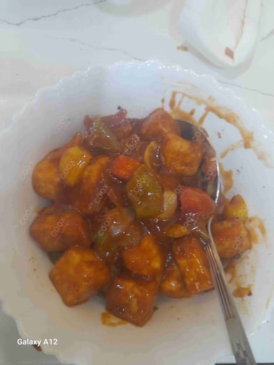 Tasty Chilli Paneer (Gravy) cooked by COOX chefs cooks during occasions parties events at home