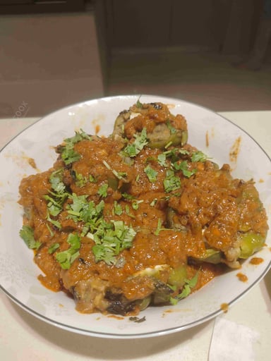 Tasty Bharwa Shimla Mirch cooked by COOX chefs cooks during occasions parties events at home