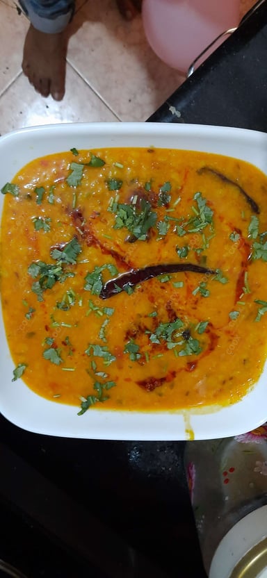Tasty Dal Tadka cooked by COOX chefs cooks during occasions parties events at home