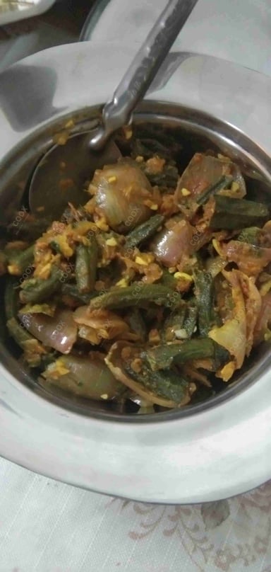 Tasty Bhindi do Pyaza cooked by COOX chefs cooks during occasions parties events at home