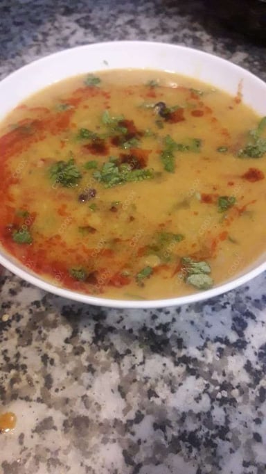 Tasty Dal Tadka cooked by COOX chefs cooks during occasions parties events at home