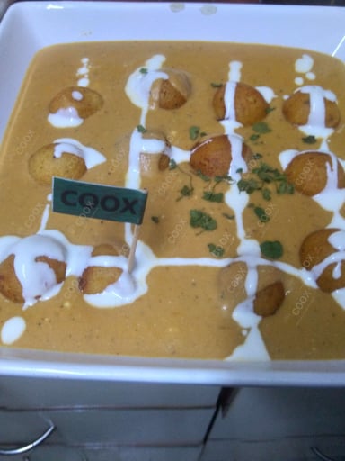 Tasty Malai Kofta (Orange Gravy) cooked by COOX chefs cooks during occasions parties events at home