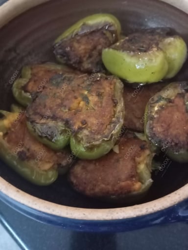 Tasty Bharwa Shimla Mirch cooked by COOX chefs cooks during occasions parties events at home