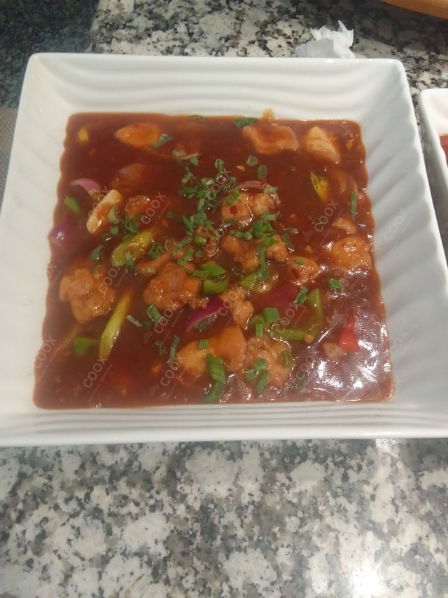 Tasty Chicken in Schezwan Sauce cooked by COOX chefs cooks during occasions parties events at home