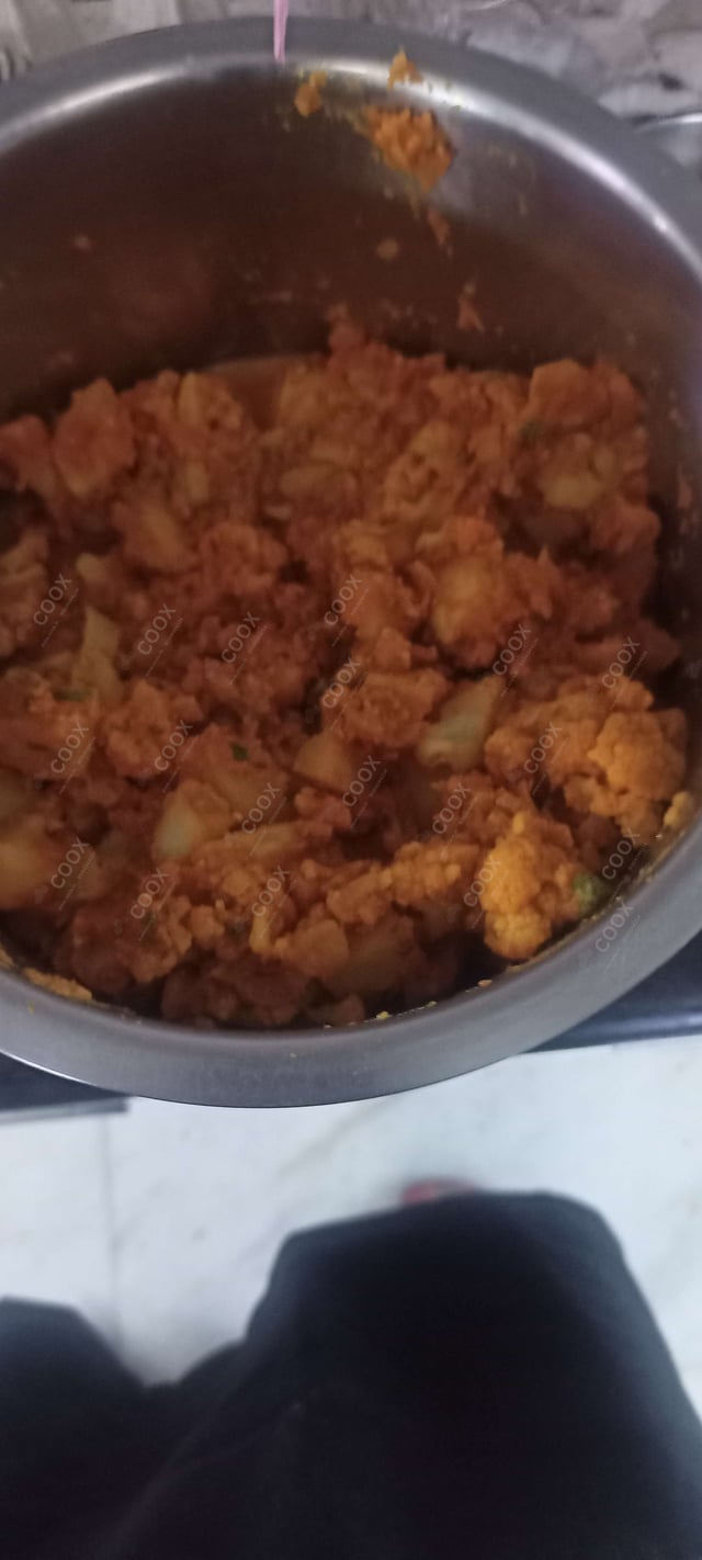 Tasty Aloo Gobhi cooked by COOX chefs cooks during occasions parties events at home