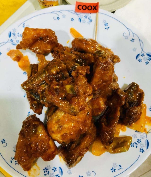 Tasty Chicken in Schezwan Sauce cooked by COOX chefs cooks during occasions parties events at home