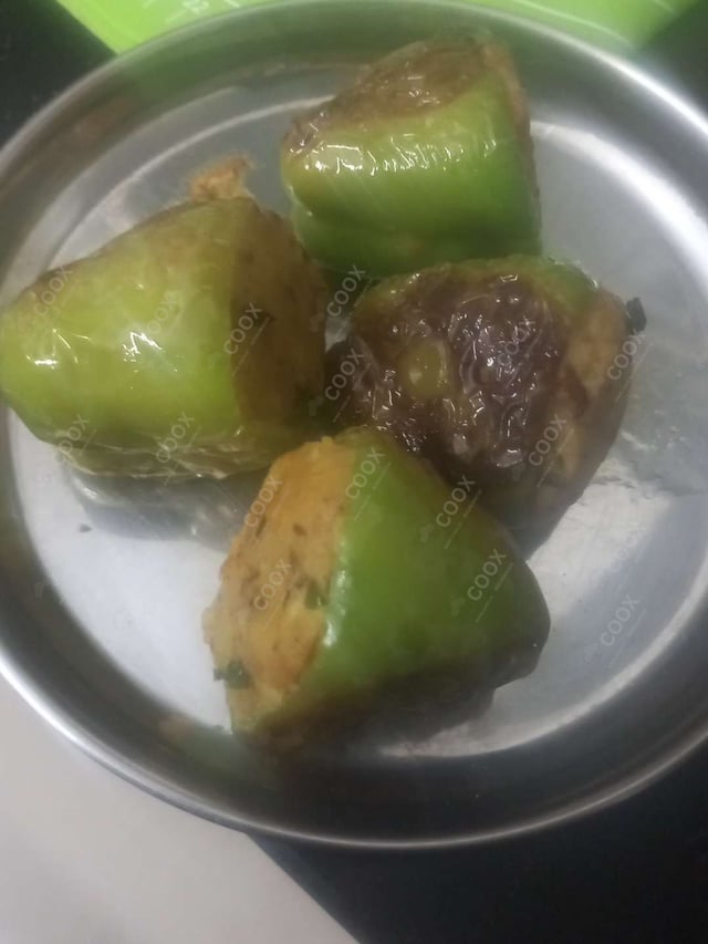 Tasty Bharwa Shimla Mirch cooked by COOX chefs cooks during occasions parties events at home