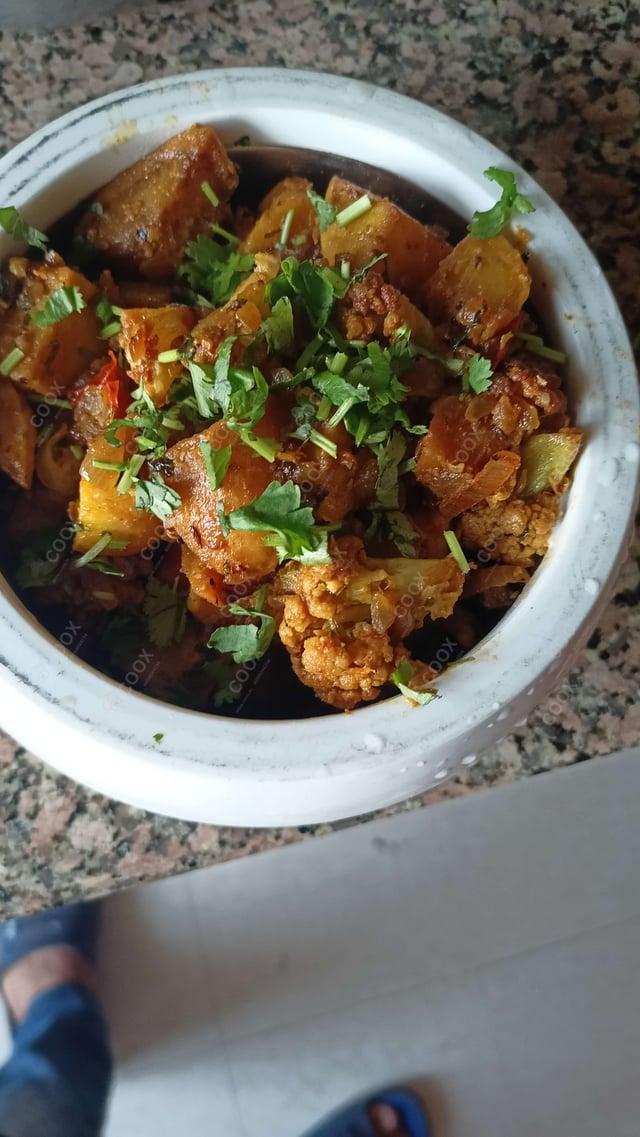Tasty Aloo Gobhi cooked by COOX chefs cooks during occasions parties events at home