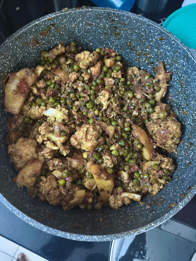 Tasty Gobhi Matar cooked by COOX chefs cooks during occasions parties events at home