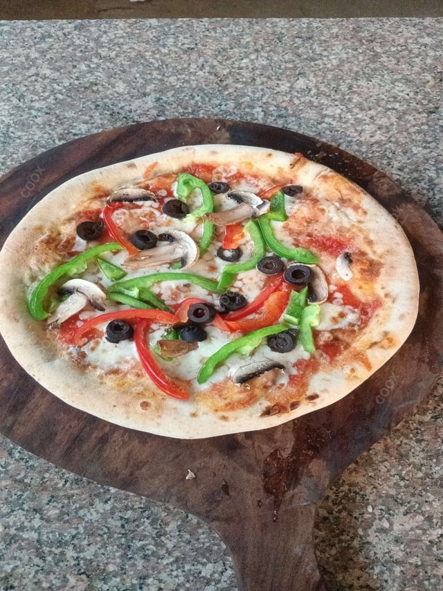 Delicious Veg Pizza prepared by COOX