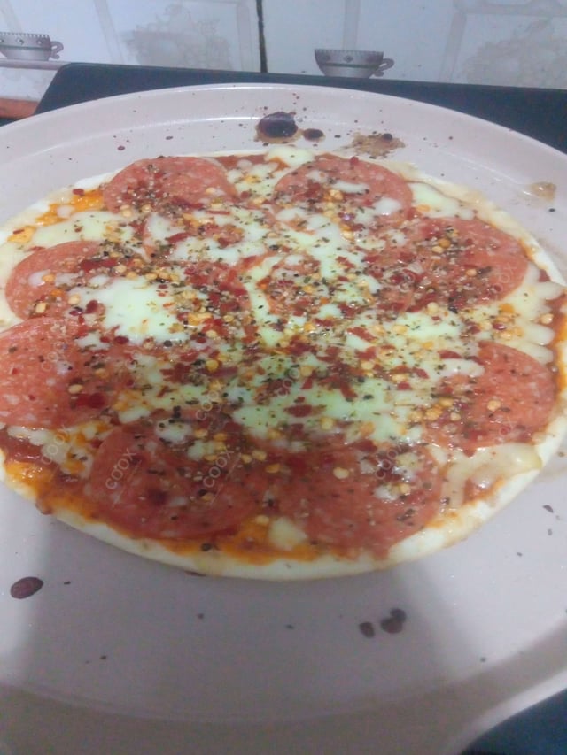 Tasty Pepperoni Pizza cooked by COOX chefs cooks during occasions parties events at home