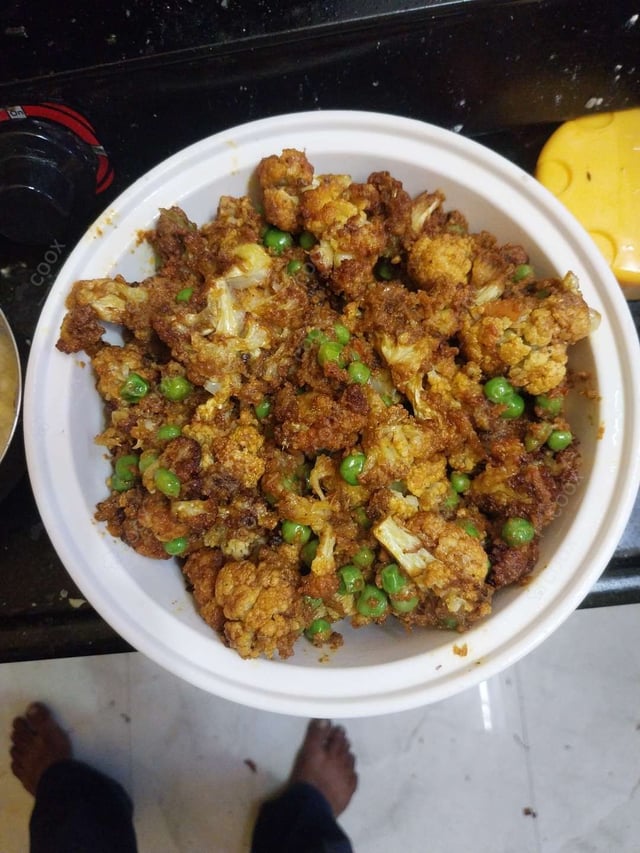 Tasty Gobhi Matar cooked by COOX chefs cooks during occasions parties events at home