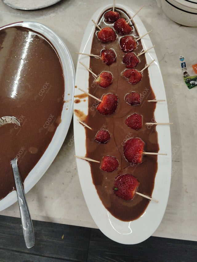 Tasty Melted Chocolate on Strawberries cooked by COOX chefs cooks during occasions parties events at home