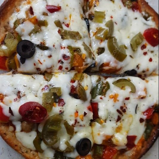 Tasty Veg Pizza cooked by COOX chefs cooks during occasions parties events at home