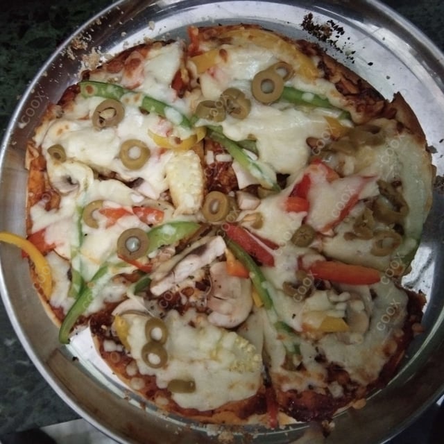 Tasty Veg Pizza cooked by COOX chefs cooks during occasions parties events at home
