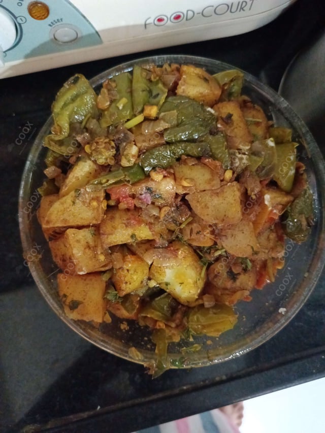 Tasty Aloo Shimla Mirch cooked by COOX chefs cooks during occasions parties events at home