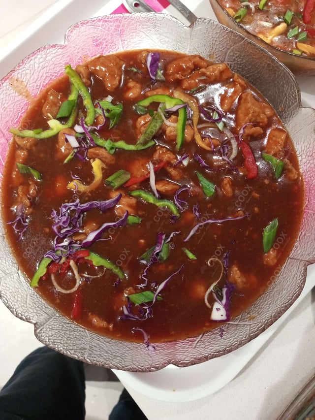 Tasty Chicken in Schezwan Sauce cooked by COOX chefs cooks during occasions parties events at home