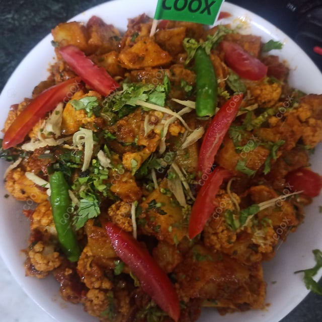 Tasty Aloo Gobhi cooked by COOX chefs cooks during occasions parties events at home