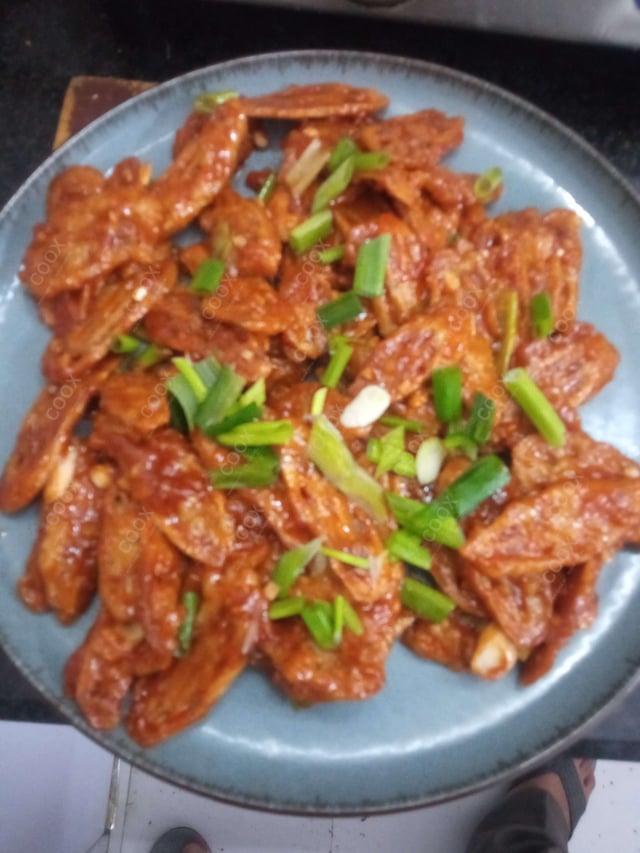Tasty Chilli Lotus Stem cooked by COOX chefs cooks during occasions parties events at home