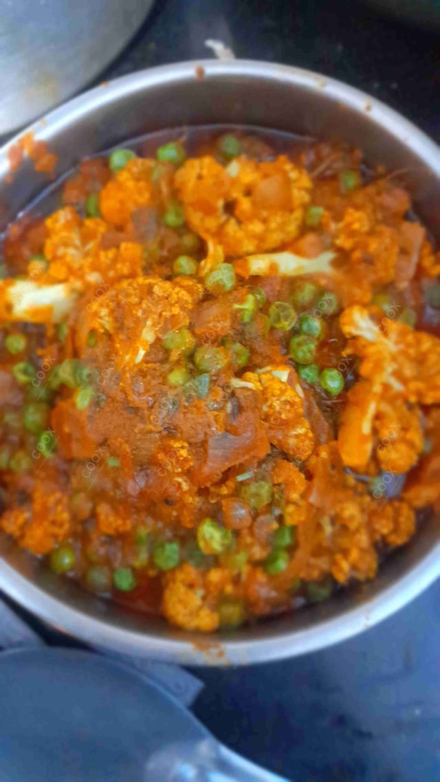 Tasty Gobhi Matar cooked by COOX chefs cooks during occasions parties events at home