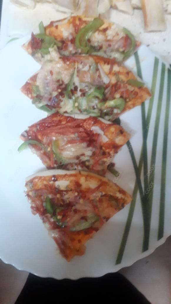 Tasty Veg Pizza cooked by COOX chefs cooks during occasions parties events at home