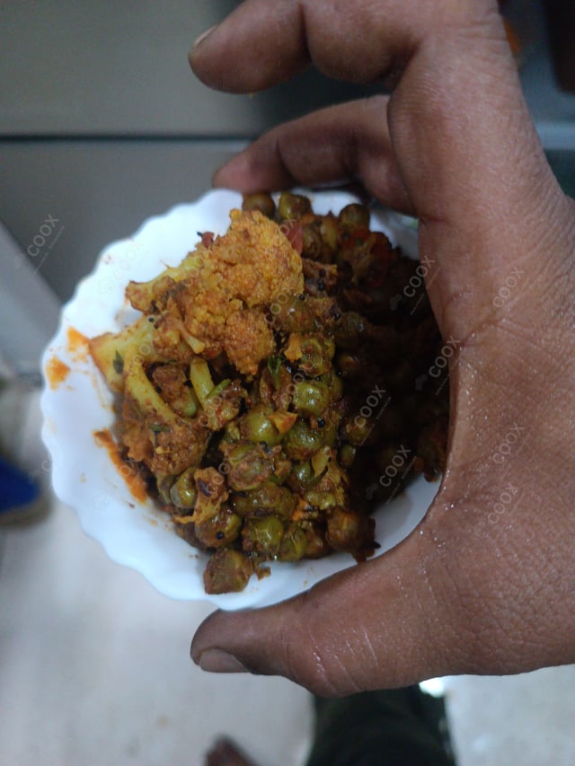 Tasty Gobhi Matar cooked by COOX chefs cooks during occasions parties events at home