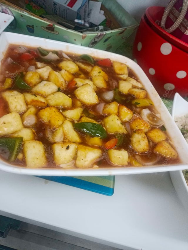Tasty Chilli Paneer (Gravy) cooked by COOX chefs cooks during occasions parties events at home