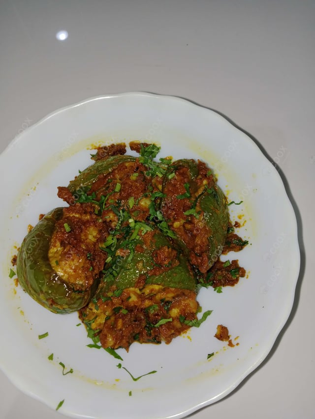 Tasty Bharwa Shimla Mirch cooked by COOX chefs cooks during occasions parties events at home