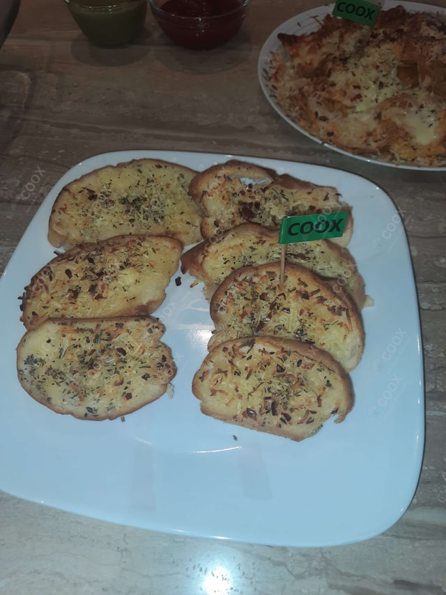 Tasty Garlic Bread with Cheese cooked by COOX chefs cooks during occasions parties events at home