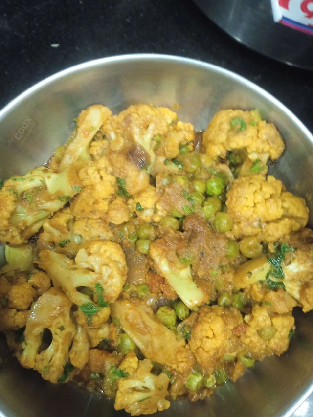 Tasty Gobhi Matar cooked by COOX chefs cooks during occasions parties events at home