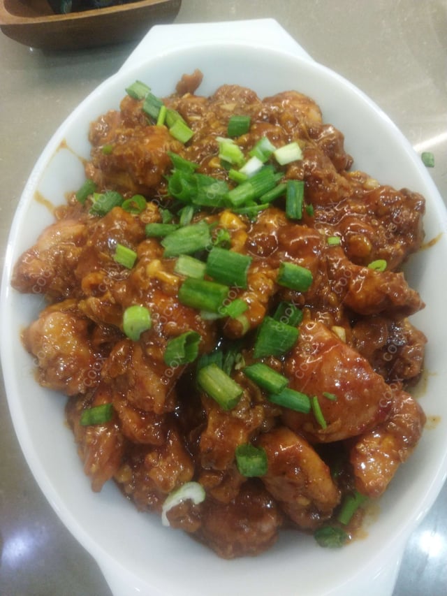 Tasty Chicken in Schezwan Sauce cooked by COOX chefs cooks during occasions parties events at home